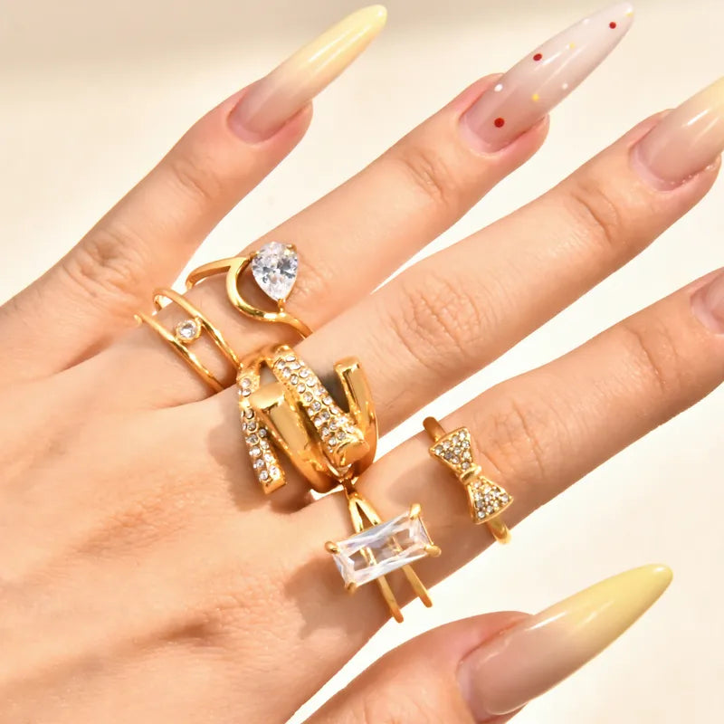 Double Layer Titanium Steel Gold Plated Ring With Large Embedded Diamonds And Butterfly Knot Irregular Geometry Crossed Square